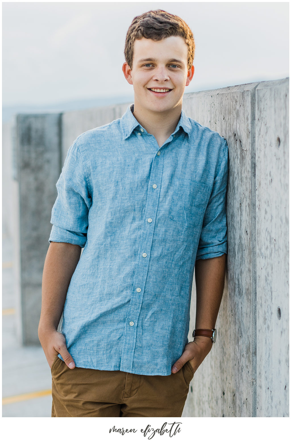 UVU boy senior pictures by Maren Elizabeth Photography taken on the top level of the Utah Valley University parking garage. | Arizona Senior Photographer