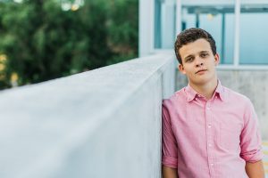 UVU boy senior pictures by Maren Elizabeth Photography taken on the top level of the Utah Valley University parking garage. | Arizona Senior Photographer