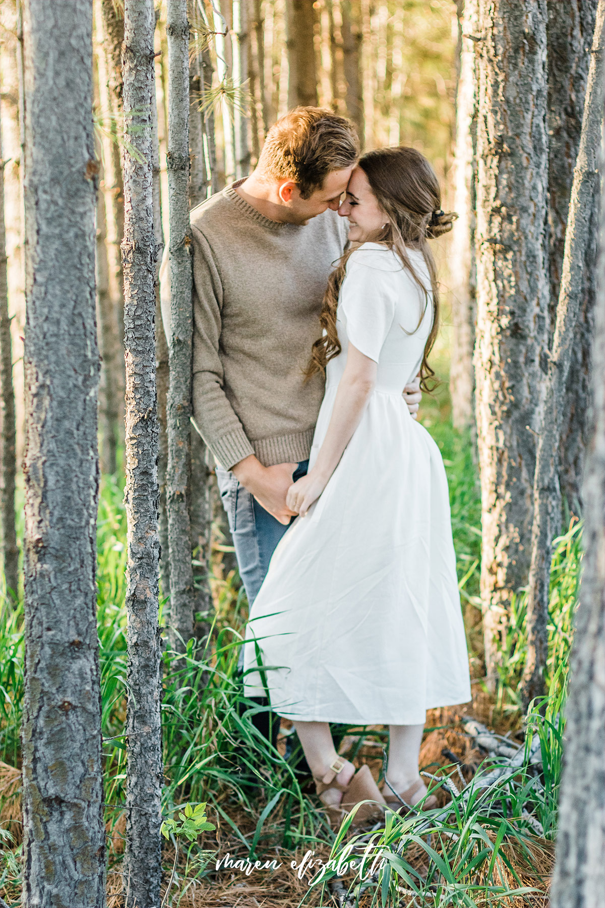 Spring engagement pictures at Burgess Orchards in Alpine, UT with a perfect view of the mountains. | Maren Elizabeth Photography