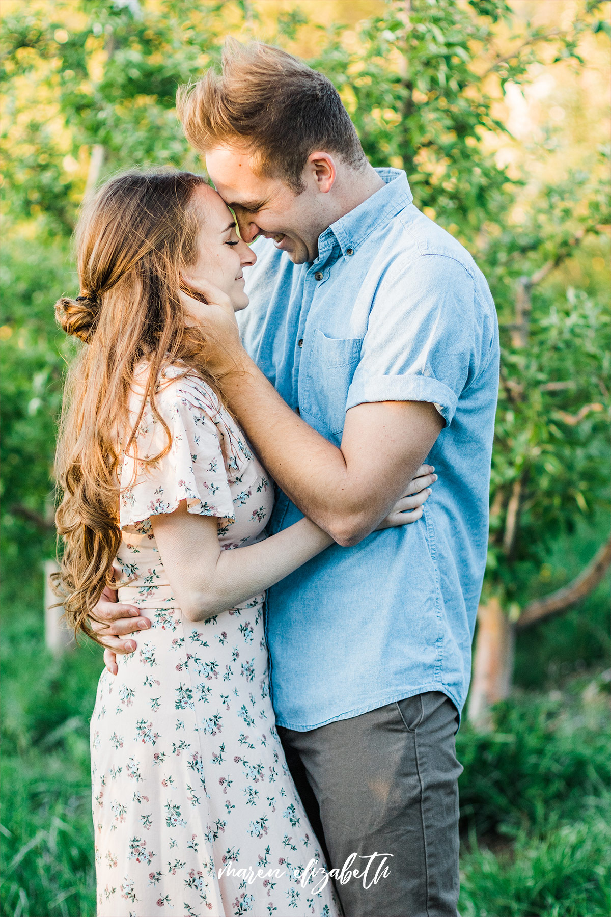 Spring engagement pictures at Burgess Orchards in Alpine, UT with a perfect view of the mountains. | Maren Elizabeth Photography